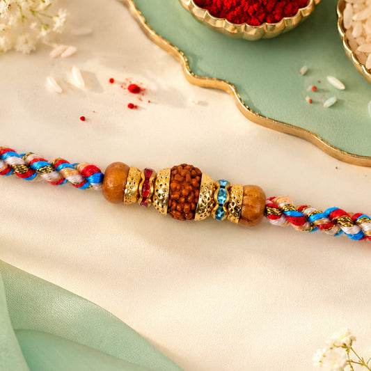 Close-up of pastel pearl rakhi with fine beads and delicate design.