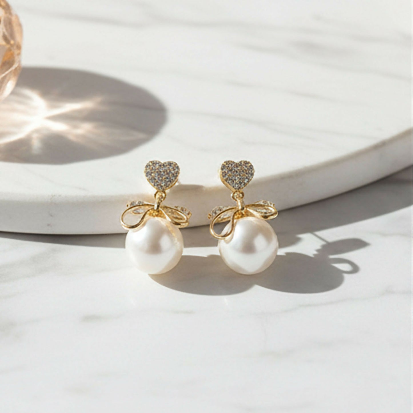 Side view of 14K gold plated Heart Crystal and Pearl Bow Earrings