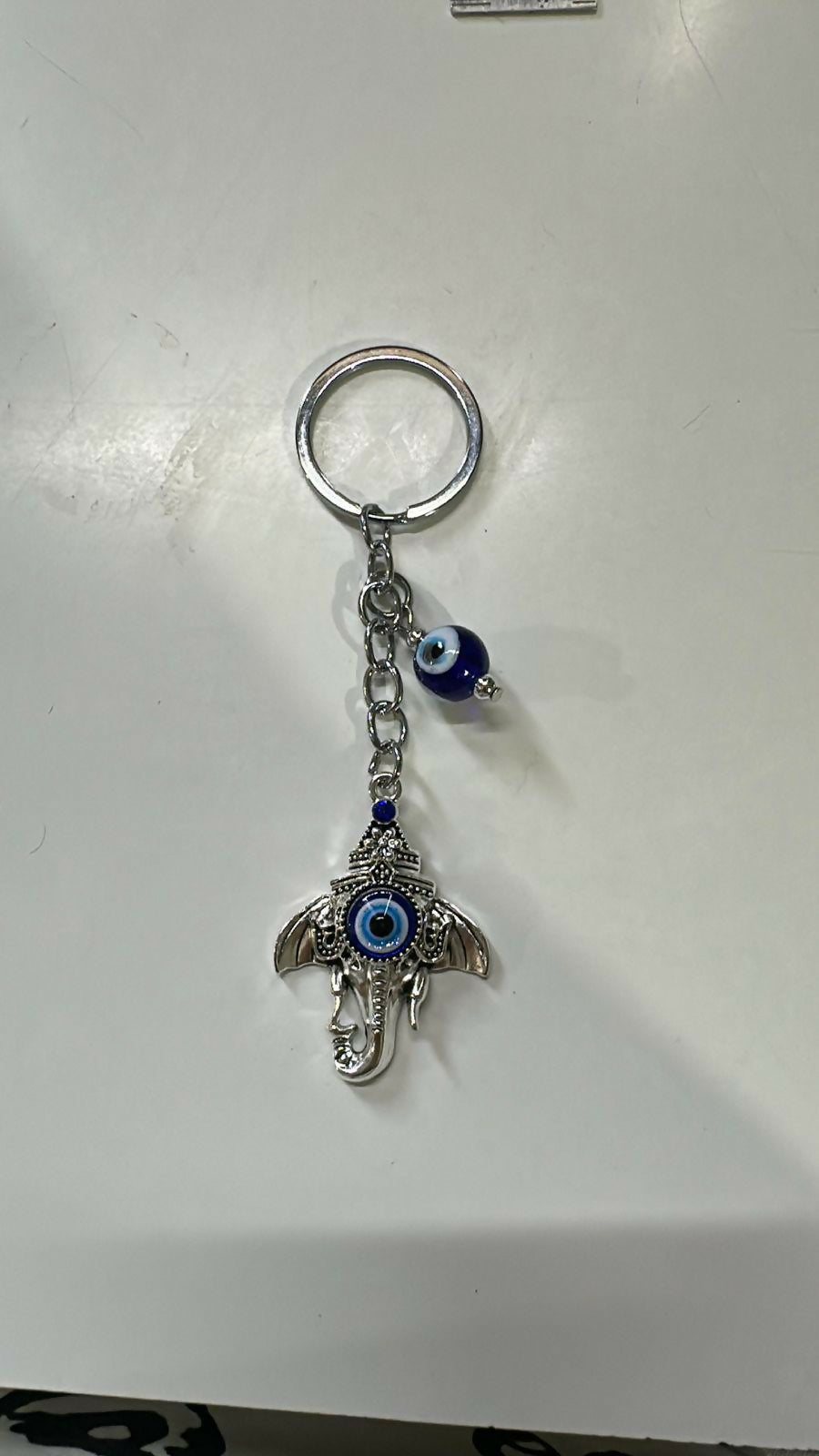 Front view of Ganesh evil eye keychain showing intricate details