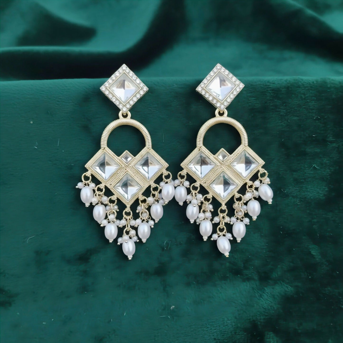Elegant Kundan chandelier earrings with geometric diamond-shaped design and pearl clusters
