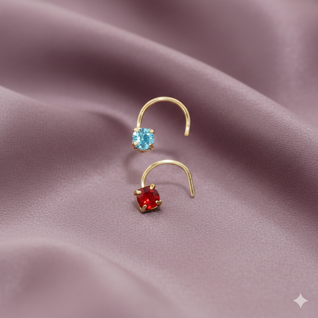 Pair of gold plated nose pins featuring emerald green and clear crystal stones
