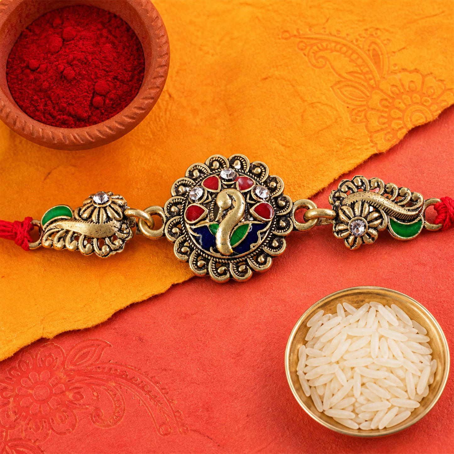 Antique Gold-Toned Peacock Rakhi with Multicolor Enamel, Crystal Accents & Red Thread
