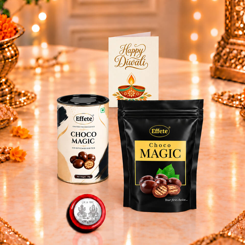 Two chocolate containers, a silver coin, and a Happy Diwali card on a reflective surface.