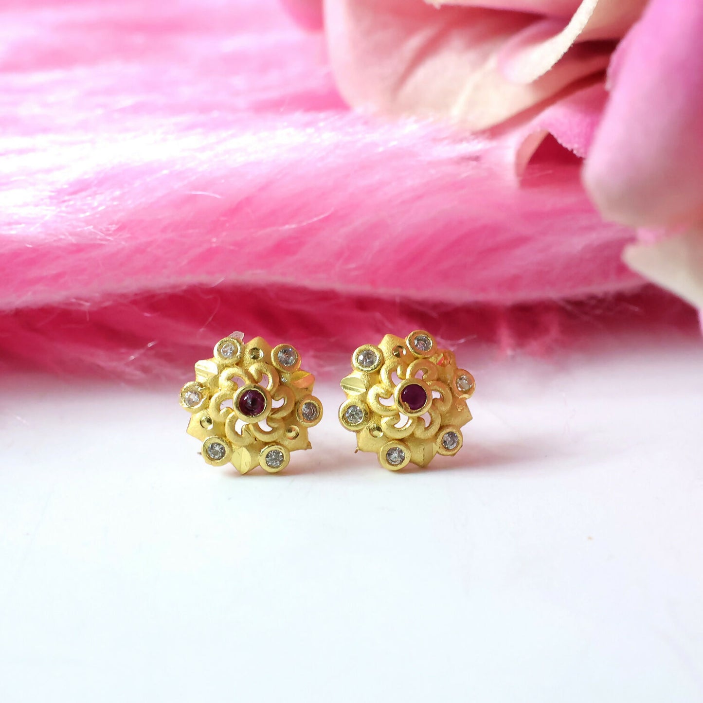 Front view of gold floral stud earrings with multi-stones
