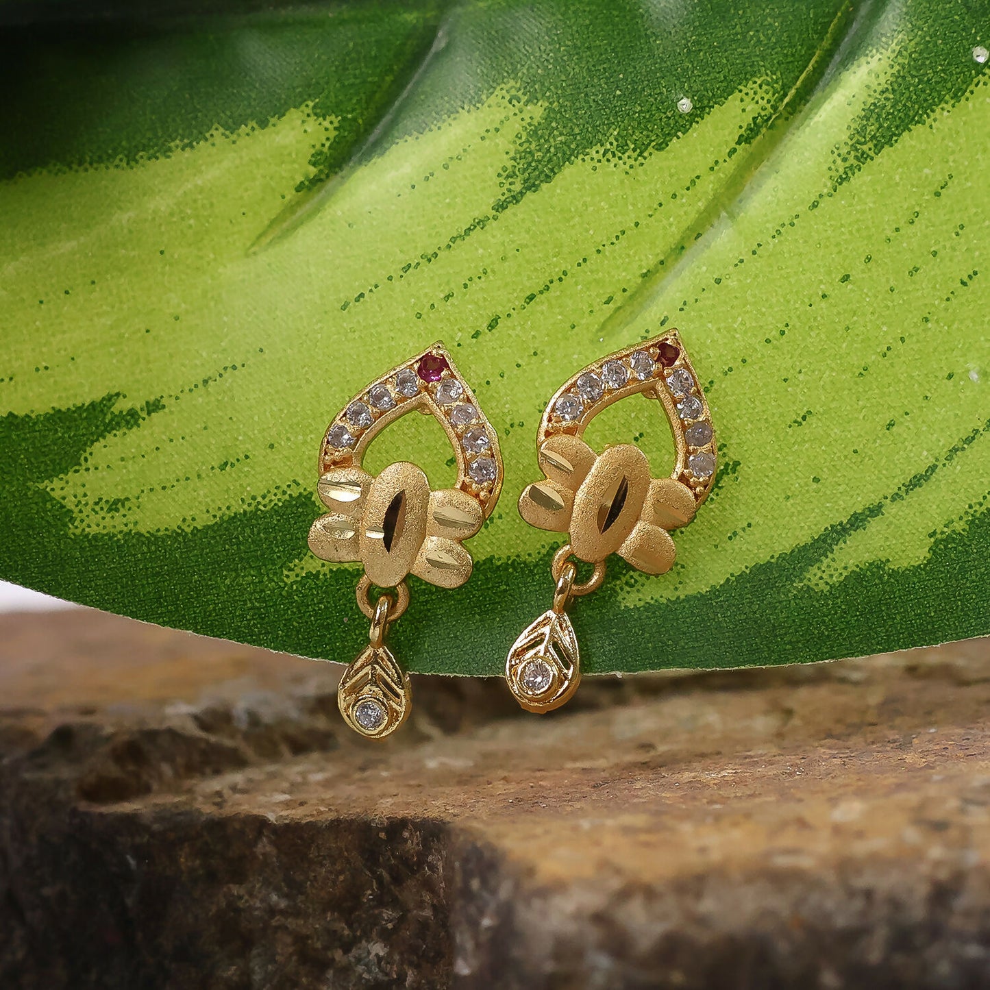 Modern Floral Gold Finish Stud Earrings With Polished Texture And Drop Accent
