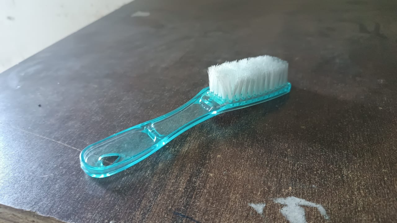 Plastic scrubbing brush with ergonomic handle