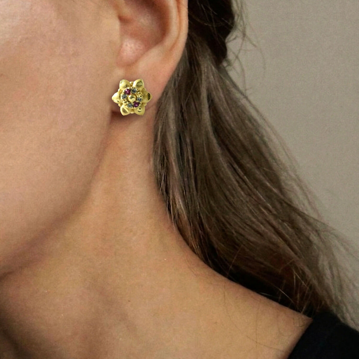 Elegant gold stud earrings with traditional motifs, perfect for gifting