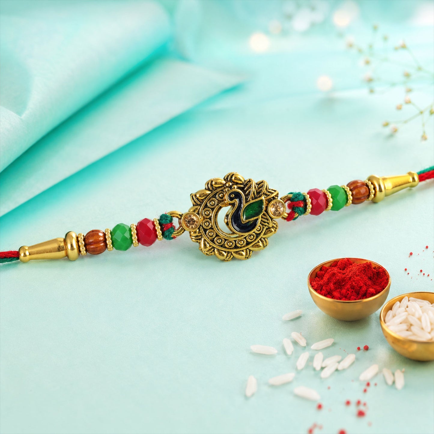 Green Peacock Enamel Rakhi with Golden Medallion, Multicolor Beads and Red Thread