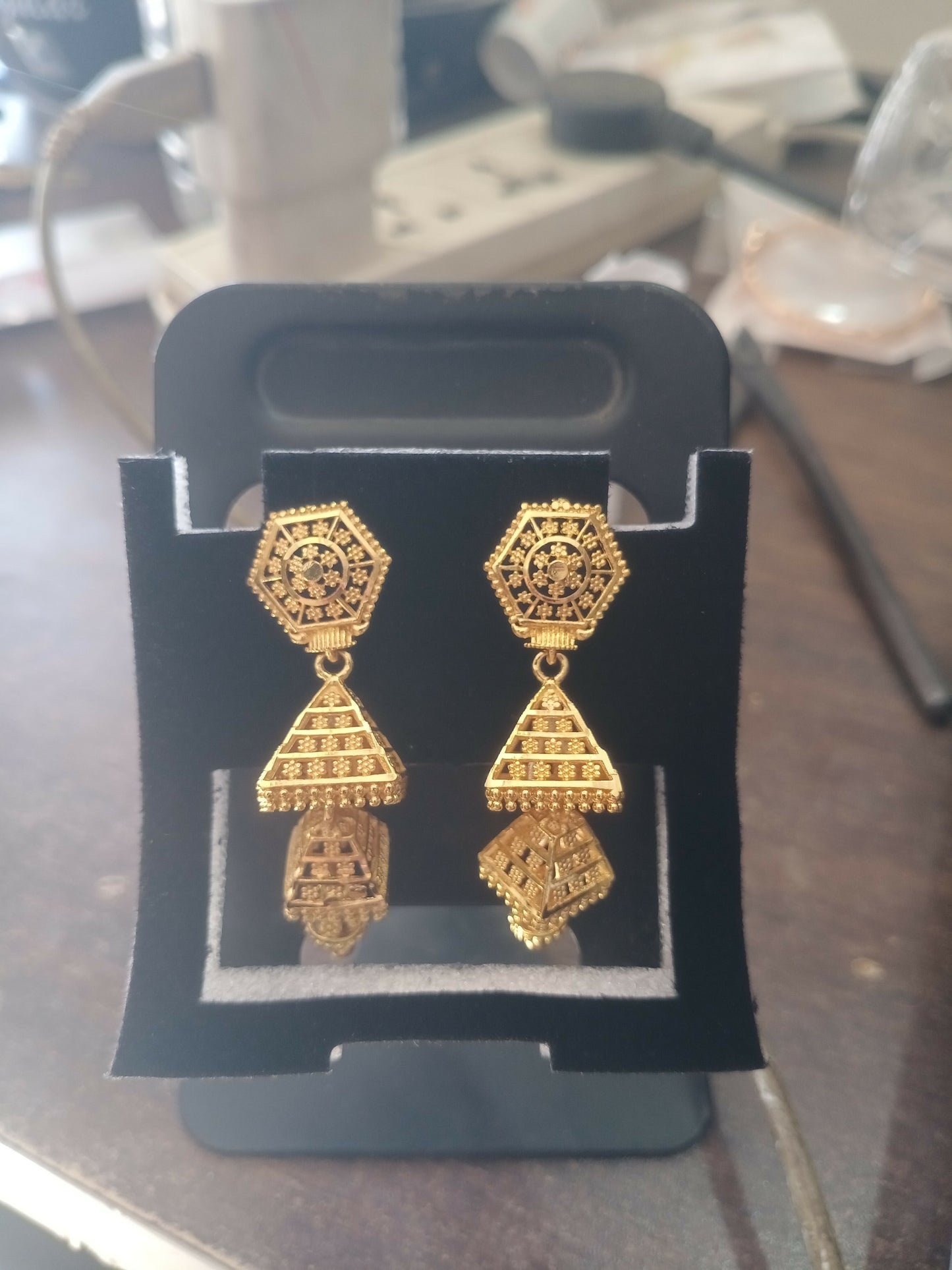 Ethnic gold-plated jhumka earrings styled with traditional Indian attire