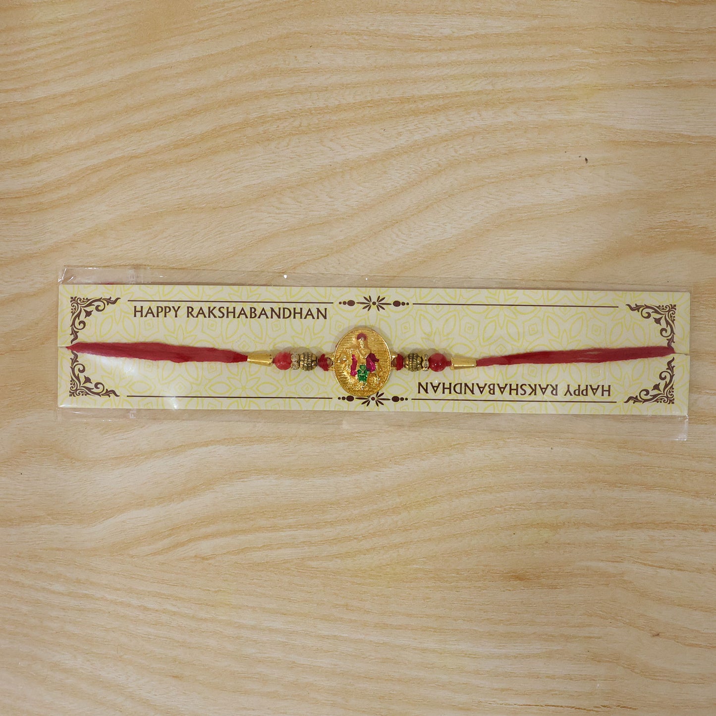 Dwarkadhish Krishna Gold Coin Rakhi with Red Beads