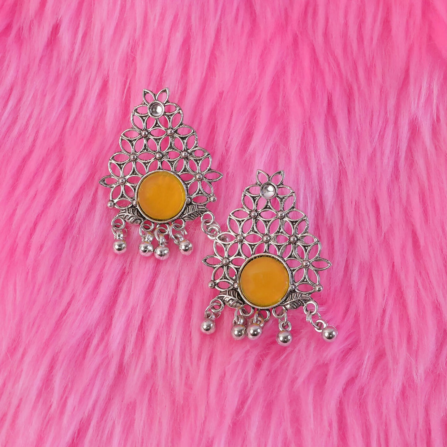 Close-up of vibrant yellow center stone on oxidized silver earrings
