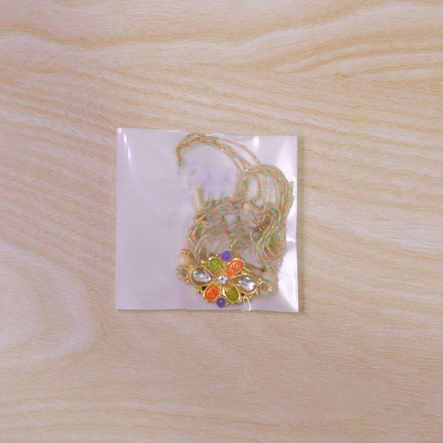 Orange and Green Enamel Flower Pendant Rakhi with Kundan Teardrop Stones