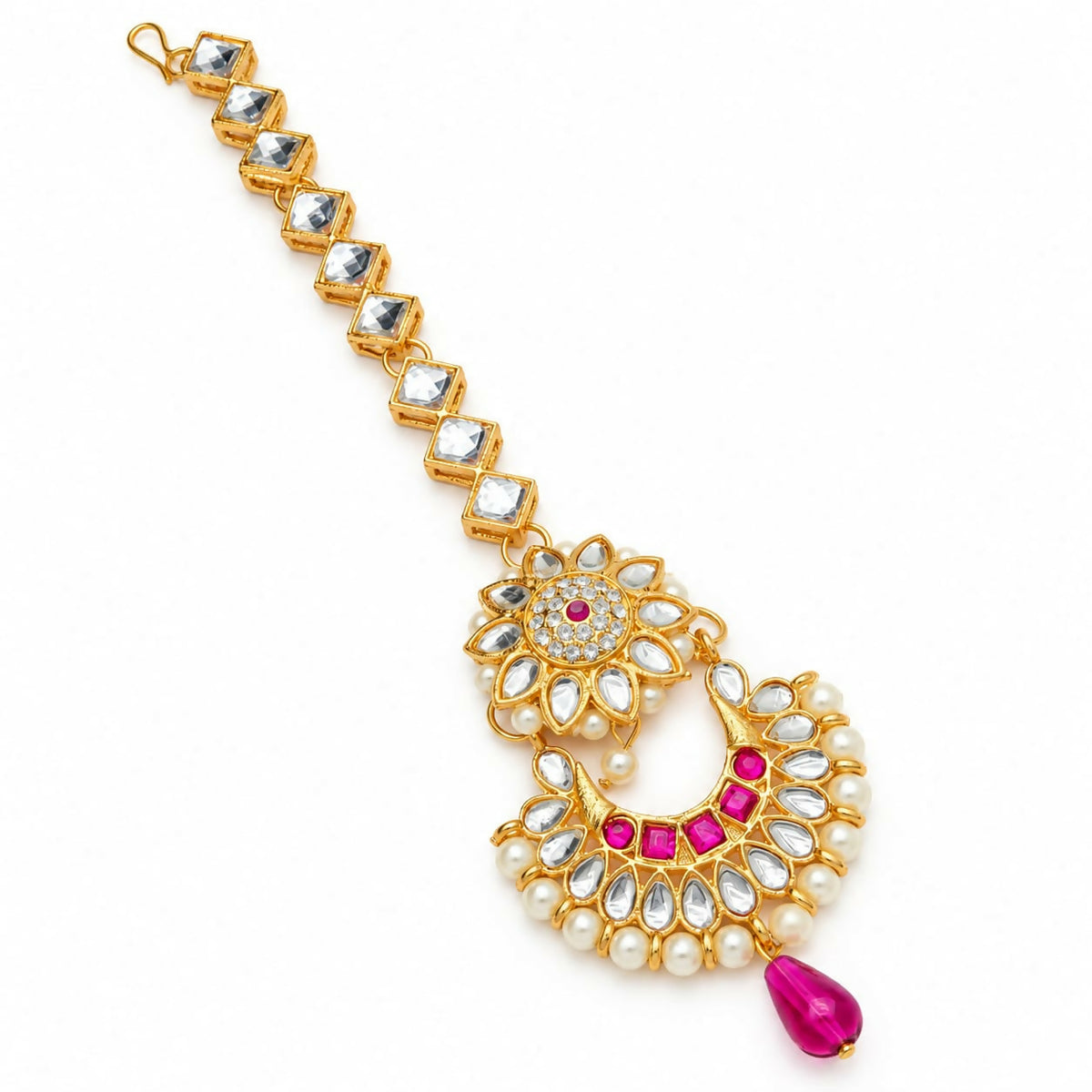 A gold maang tikka with clear square stones on the chain, a floral headpiece with pink gems, and a fuchsia teardrop pendant.