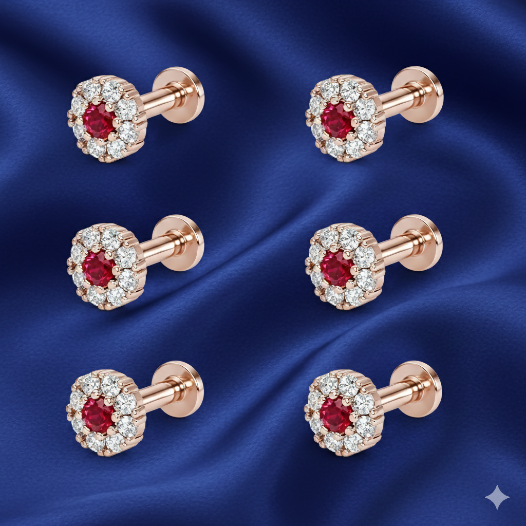 Single ruby nose pin in rose gold featuring diamond halo detail