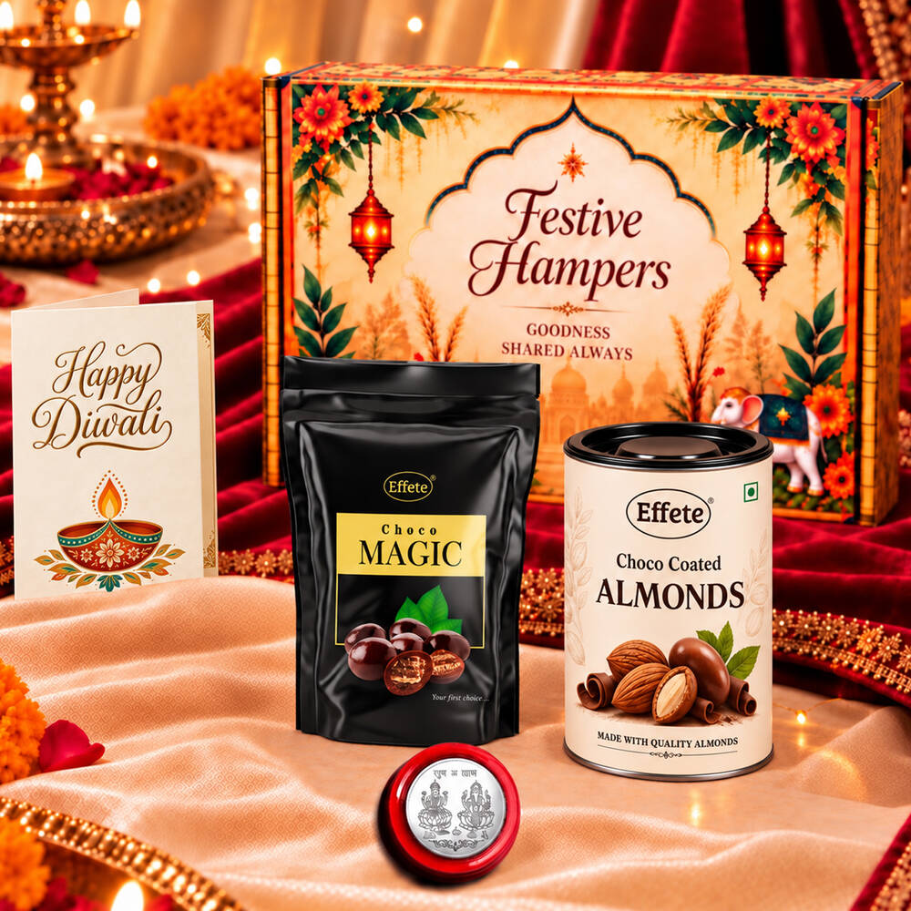 A festive hamper box with a black pouch of Choco Magic, a tin of Choco Coated Almonds, a silver coin, and a greeting card on