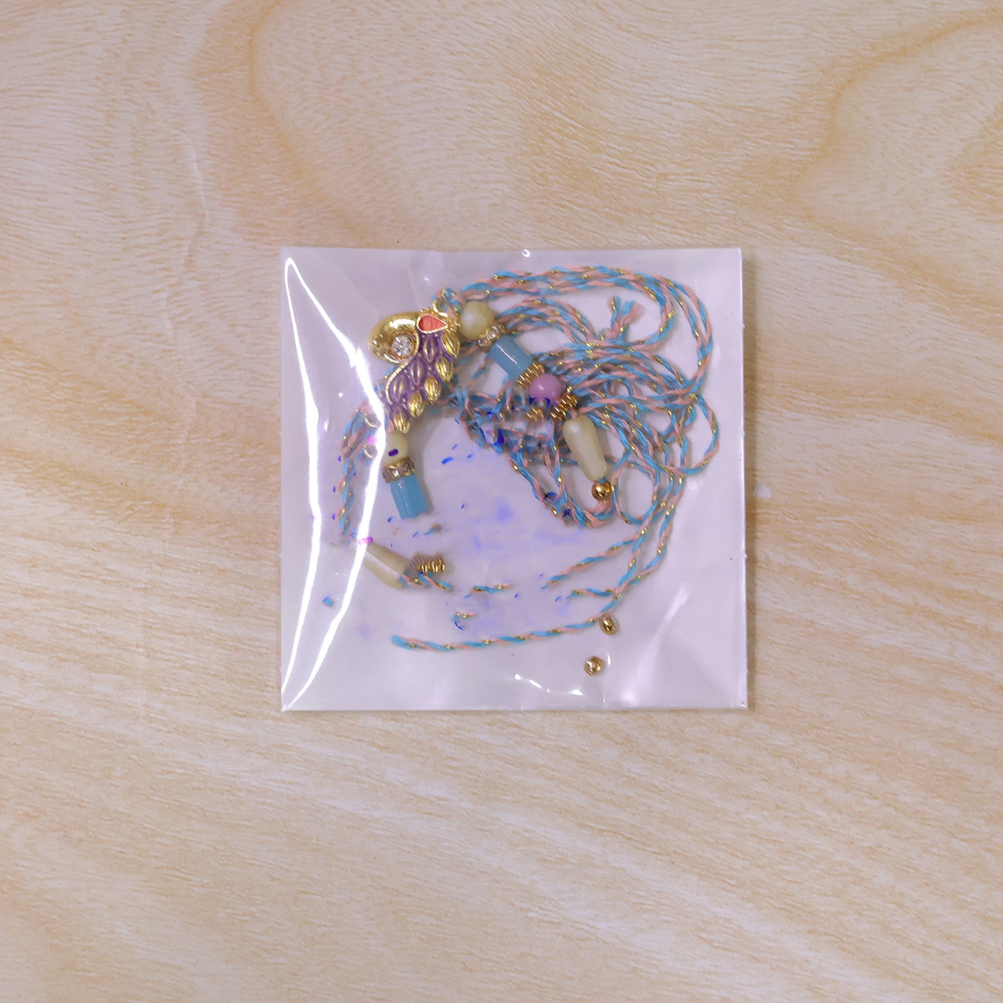 Blue Enamel Peacock Pendant Rakhi with Pastel Beads