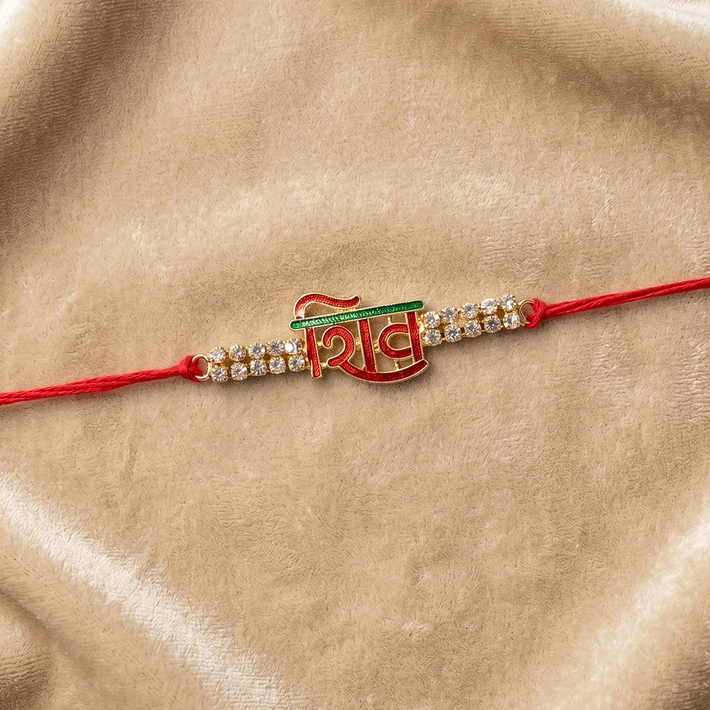 Shiv Letter Rakhi with Crystal Row and Red Mauli Thread