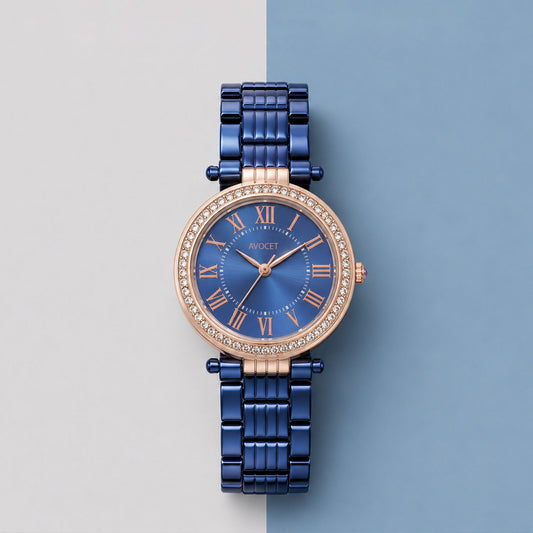 Elegant women's blue analog watch with rose gold crystal bezel and metal strap.