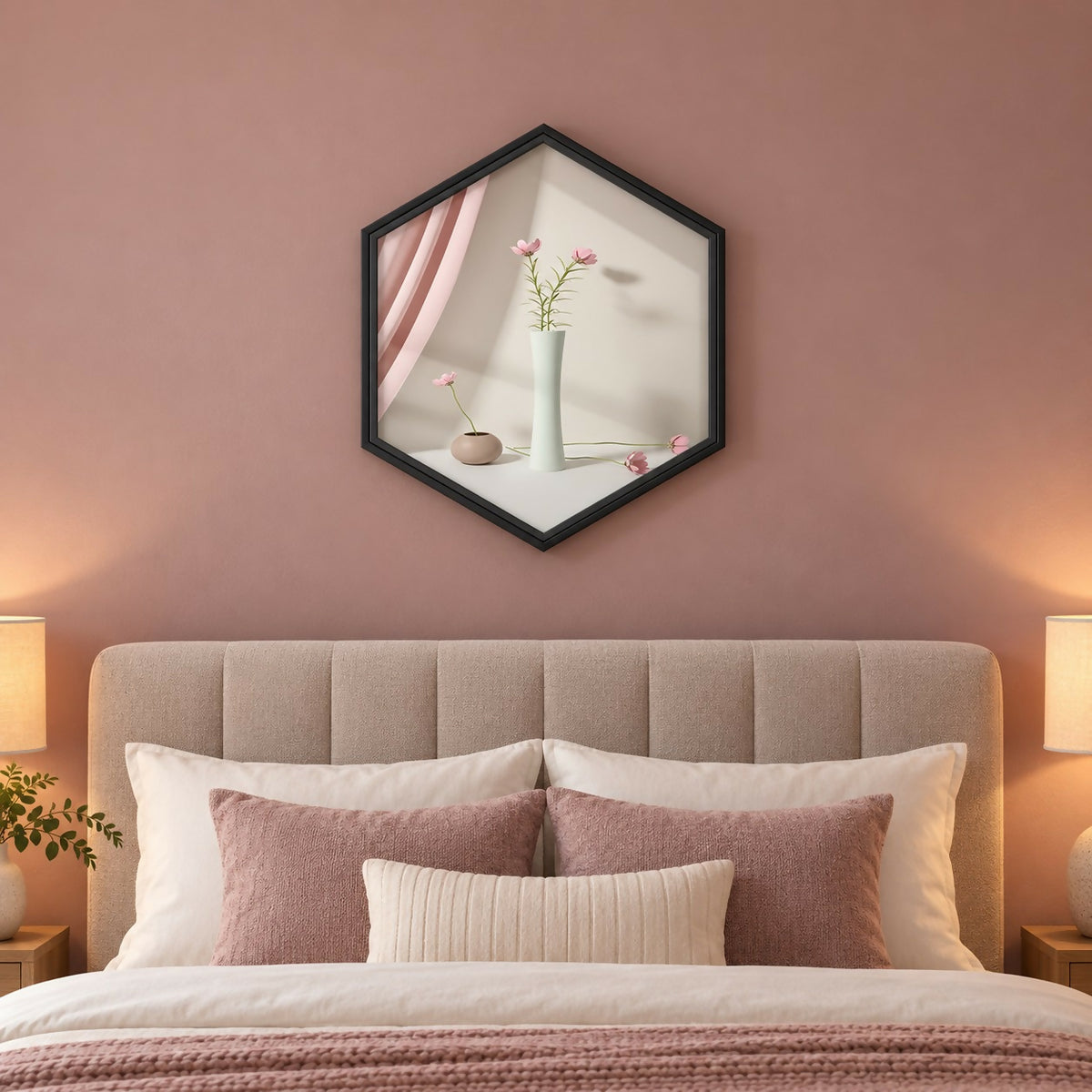 A black hexagon frame on a pink wall reflects a white vase with pink flowers and a pink curtain.