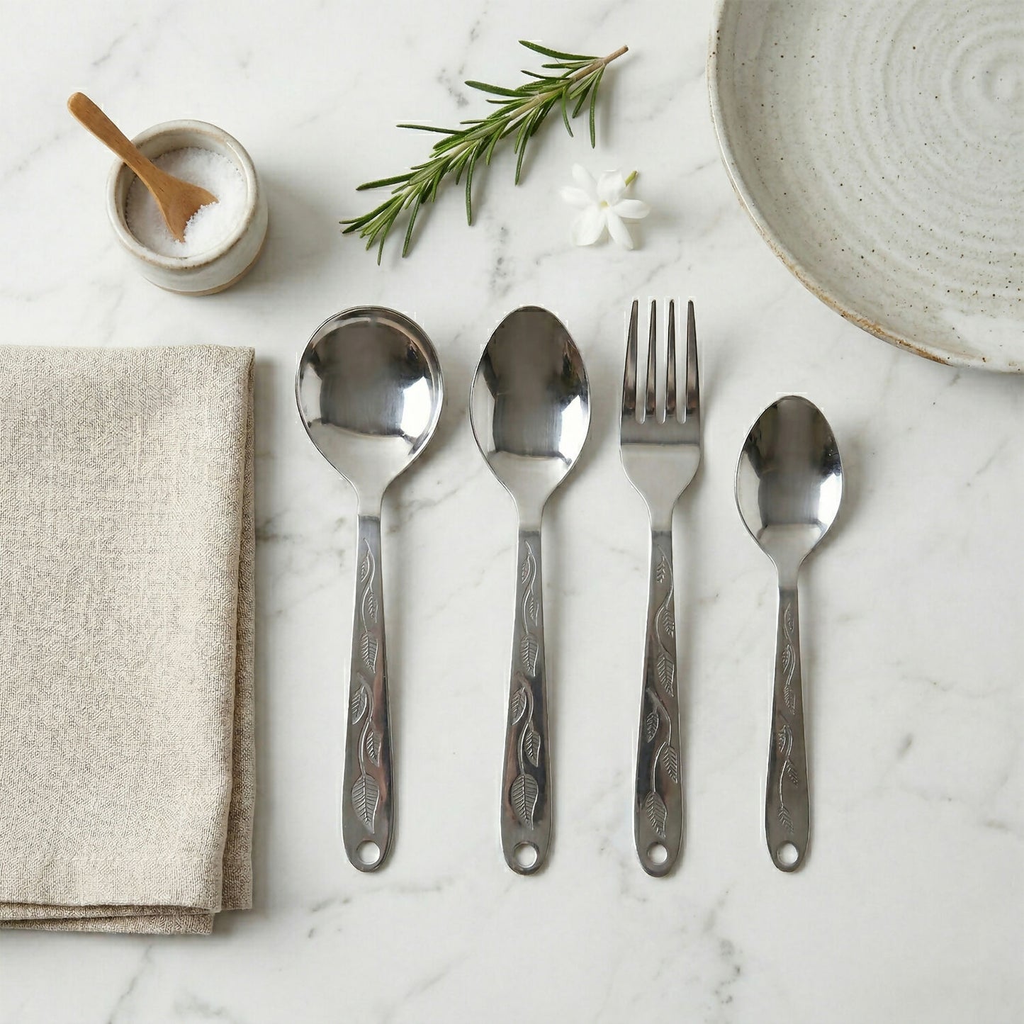 Close-up of stainless steel spoons and forks with mirror finish