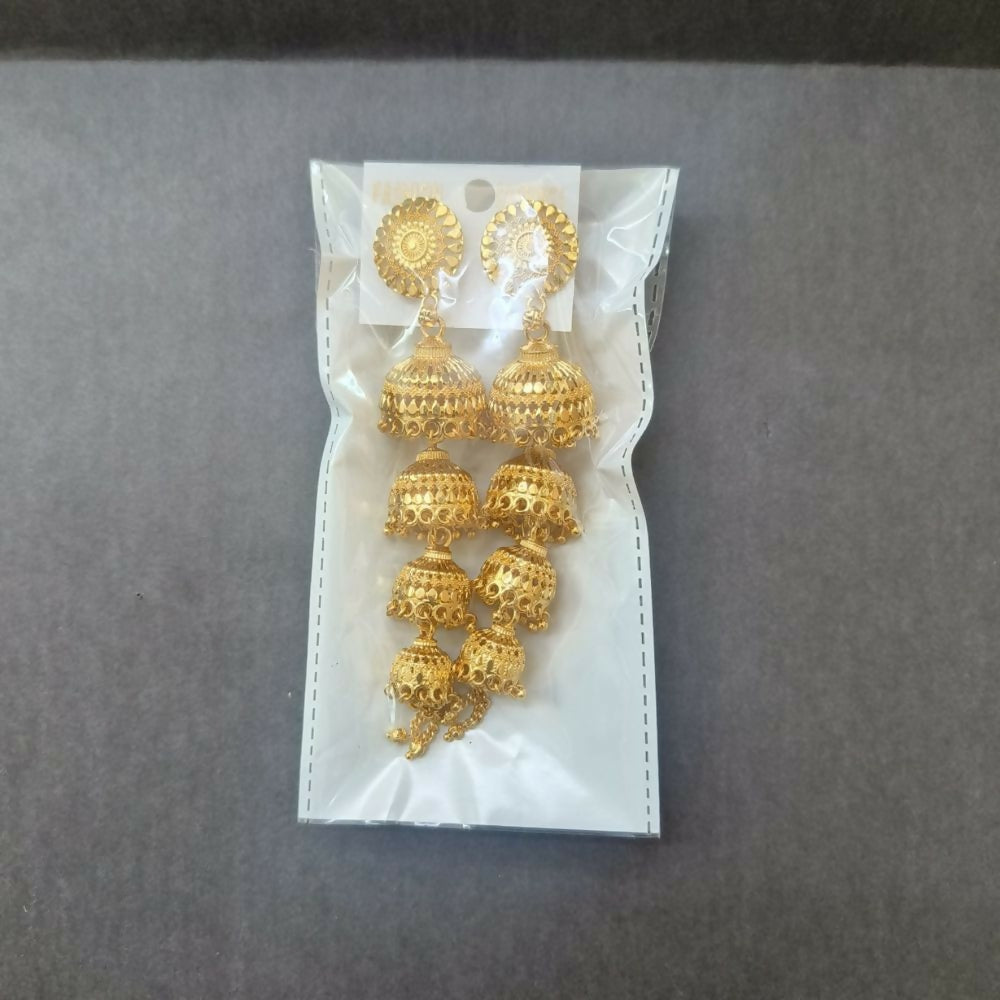 Pair of gold jhumka earrings on a white surface