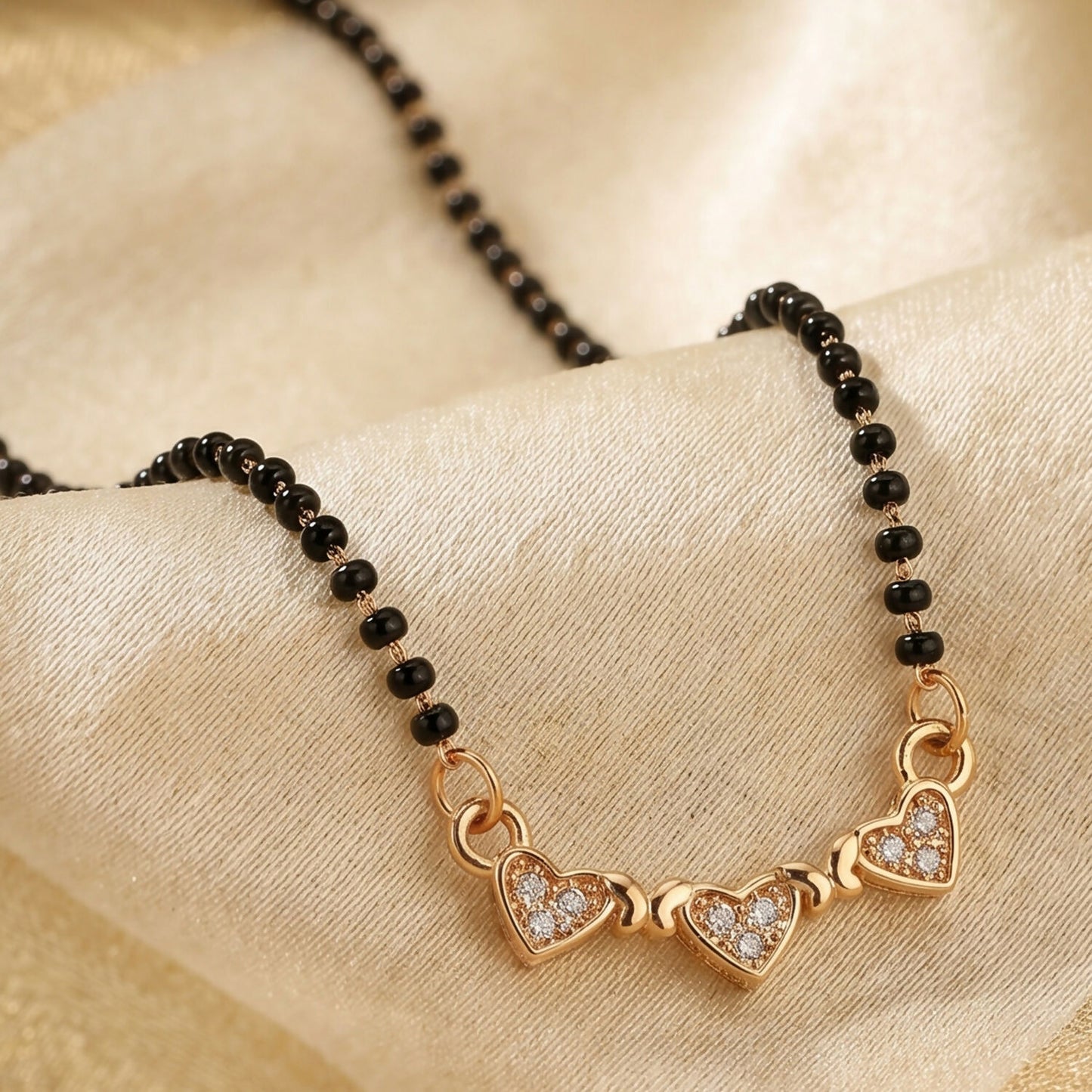 Close-up of traditional mangalsutra necklace with black bead chain and sparkling crystals.