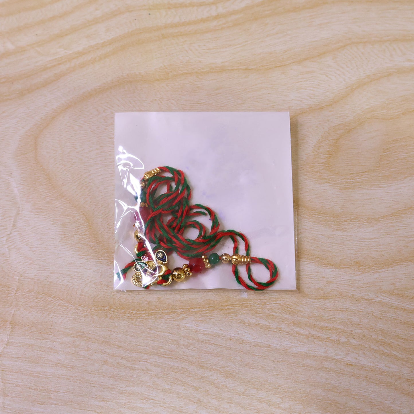 Colorful Enamel Peacock Pendant Rakhi with Red and Green Beads