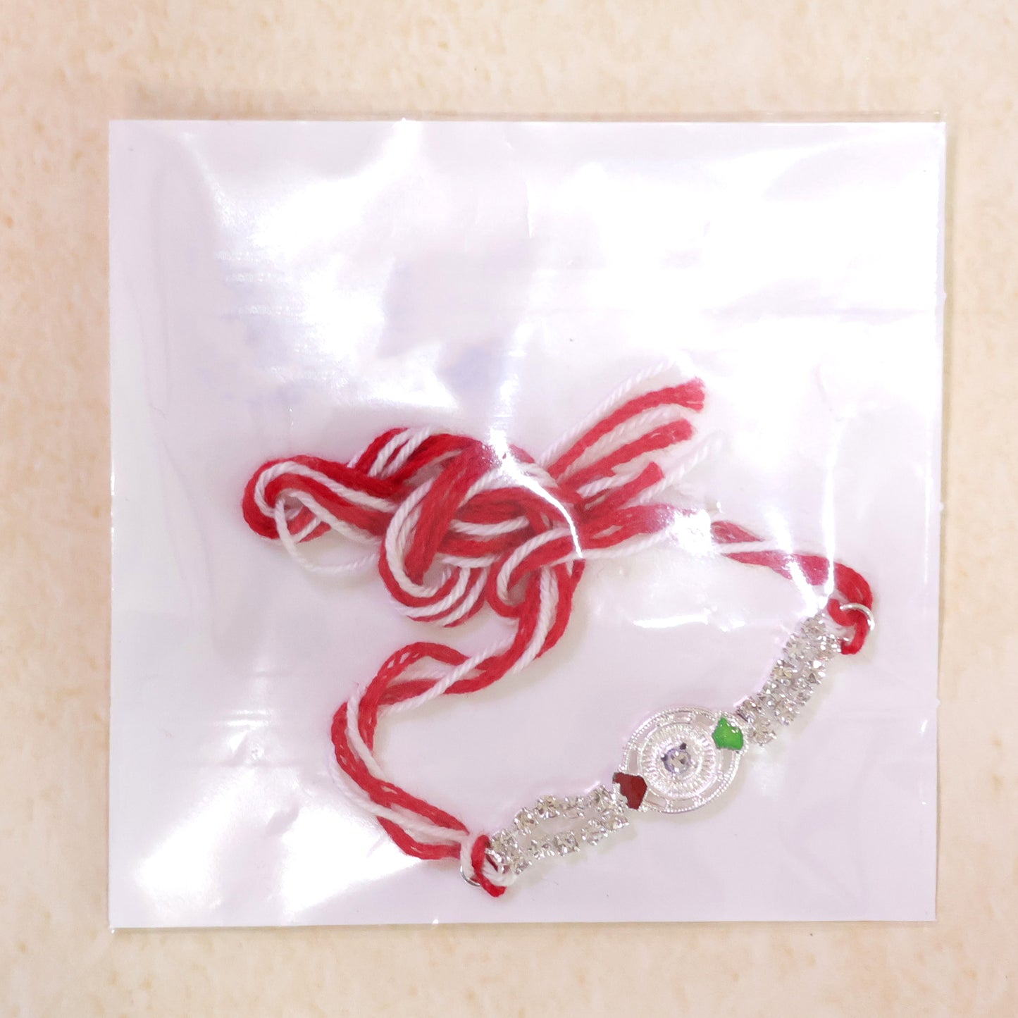 Silver-Toned Peacock Rakhi with Multicolor Enamel, Double Crystal Chain & Red Thread