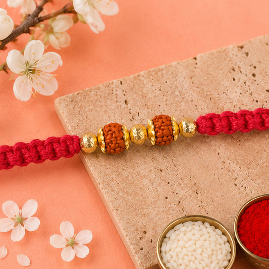 Close-up view of a designer rakhi with a sparkling studded centre and festive beads.