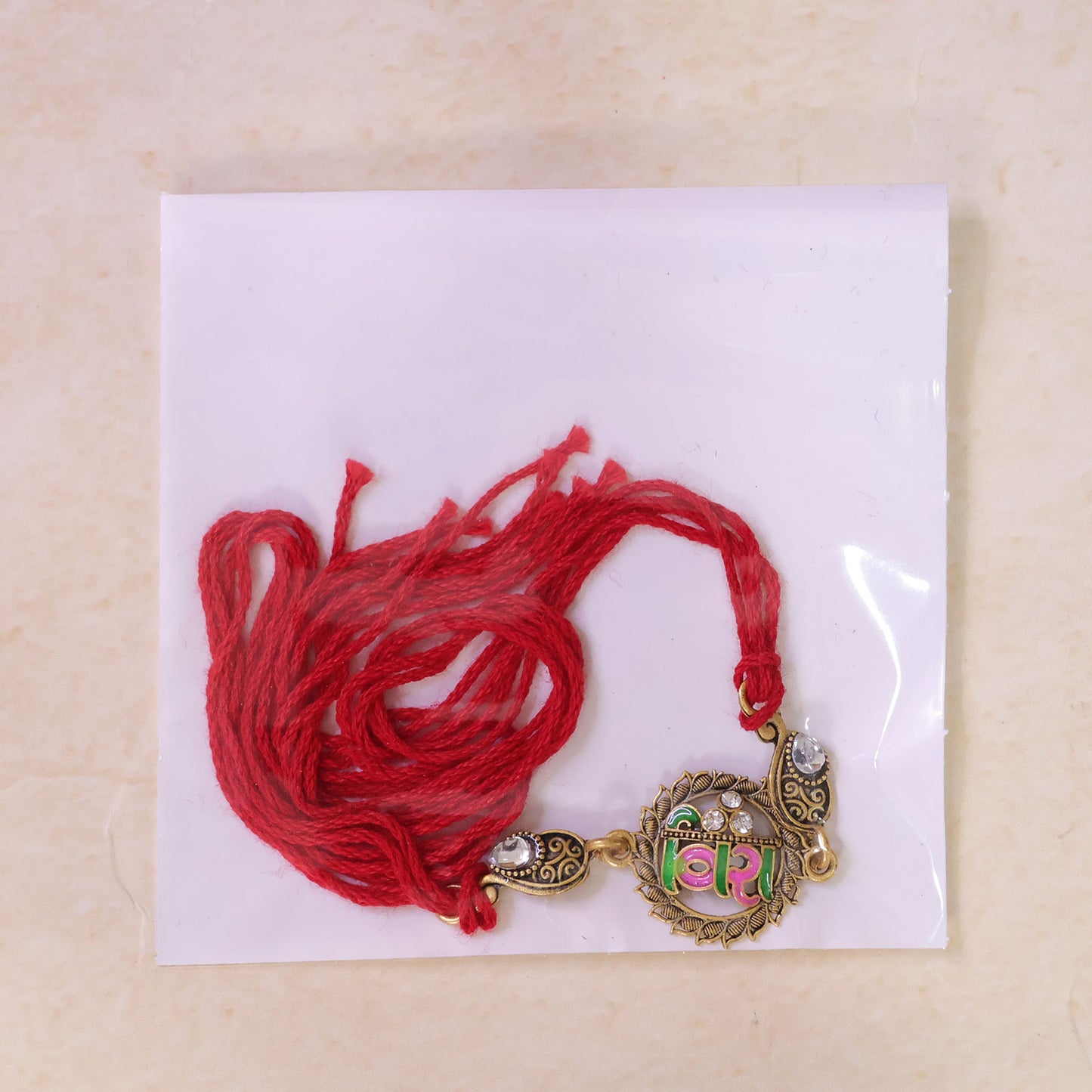 Antique Gold-Toned Veera Rakhi with Pink-Green Enamel, Crystal Accents & Red Thread