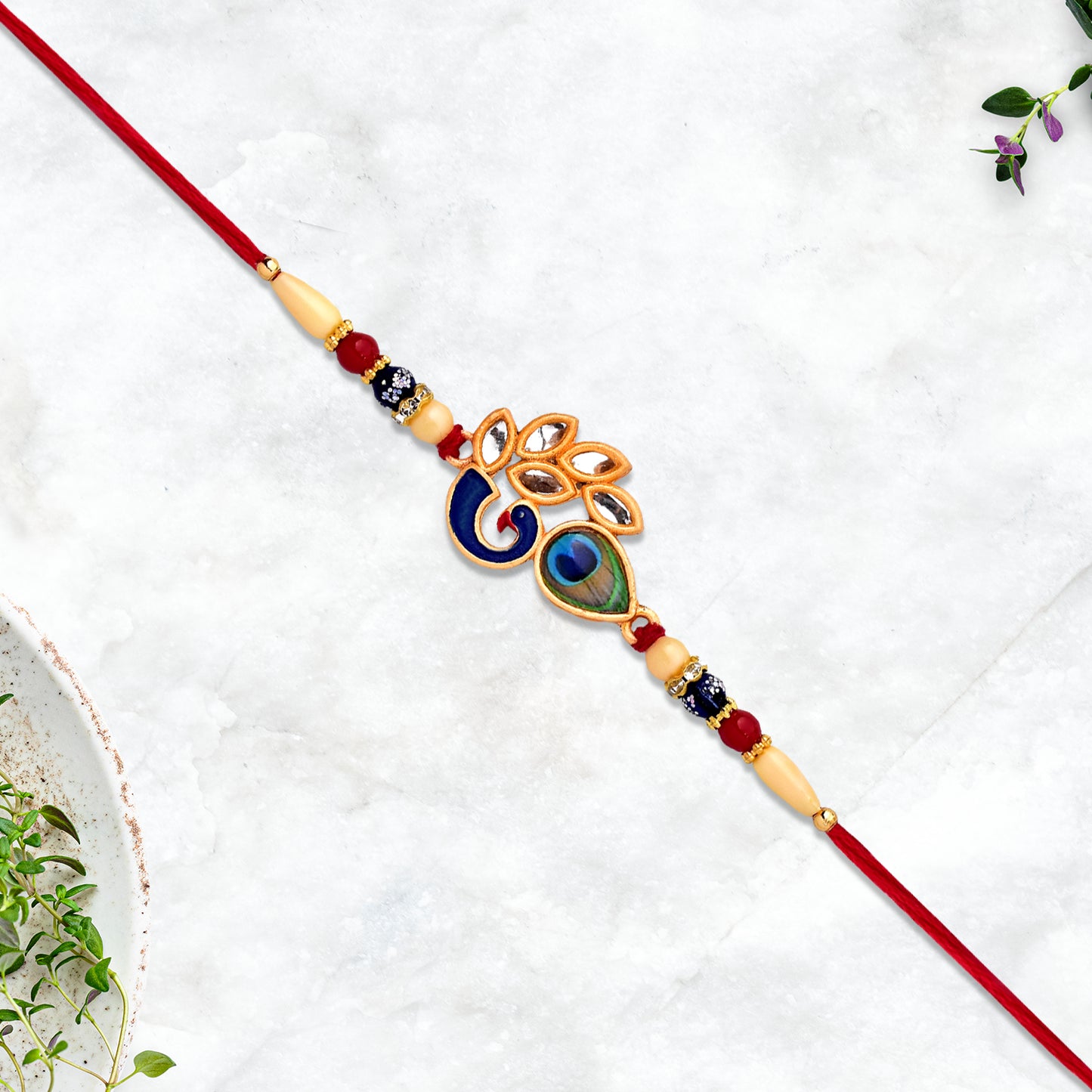 Mor Pankh Rakhi displayed on a decorative surface