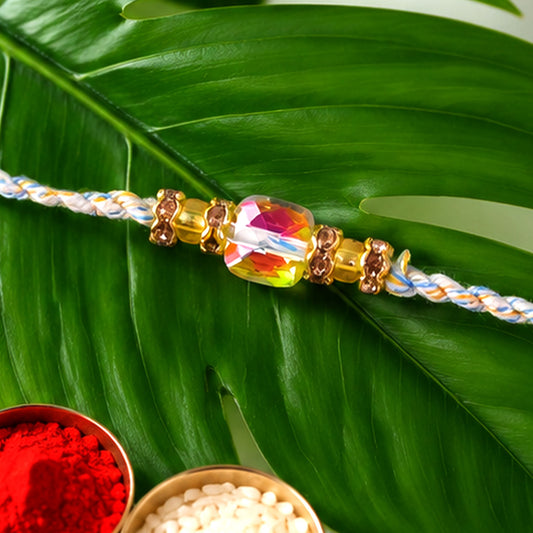 Close-up of Aurora Crystal Macrame Rakhi with rainbow stone sparkle.