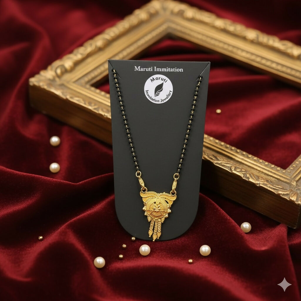 This stunning pendant, made of durable imitation metal and finished in gold tone, features detailed craftsmanship and a regal tassel drop.