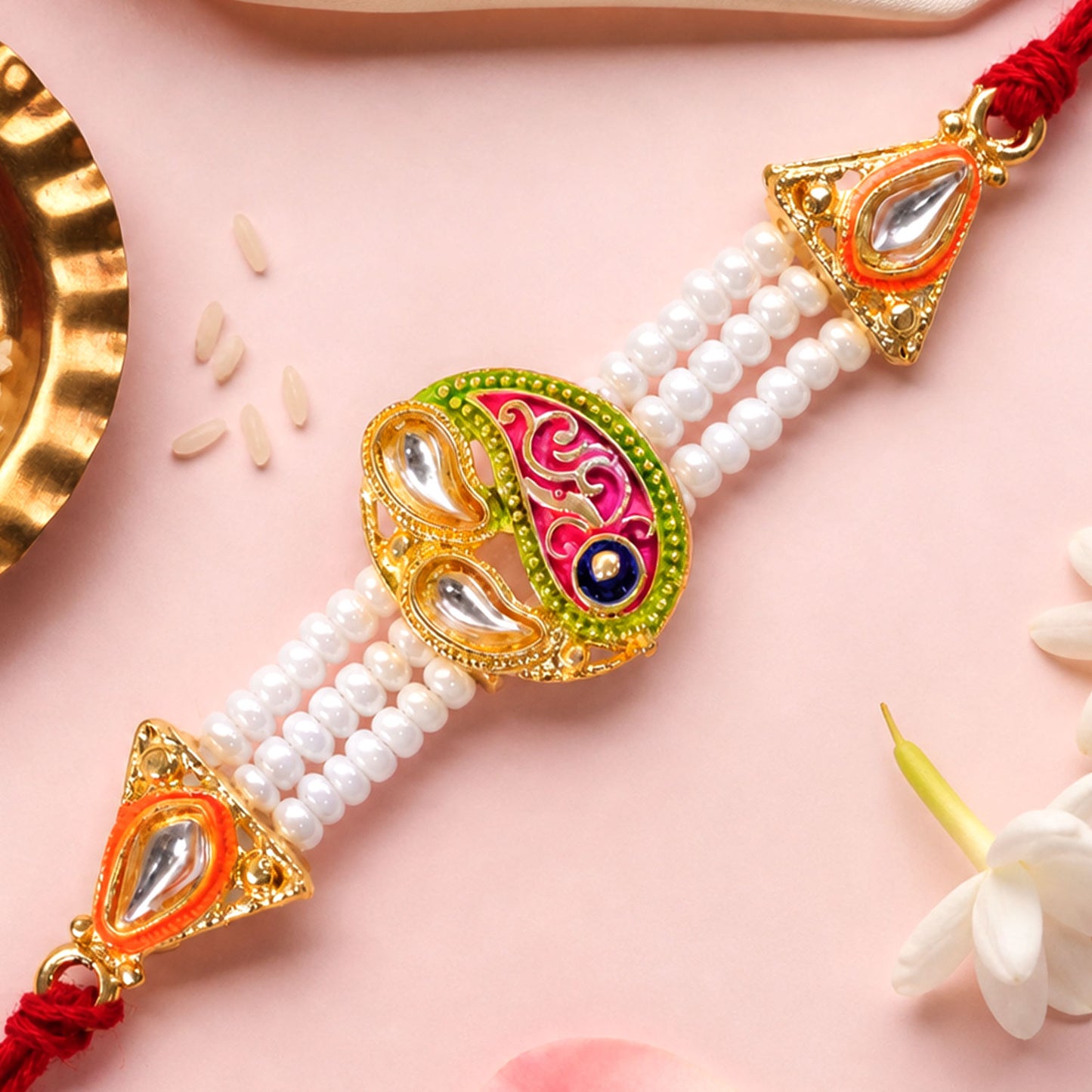 Pearl Paisley Rakhi with Red Thread and Golden Festive Brother Gift Presentation