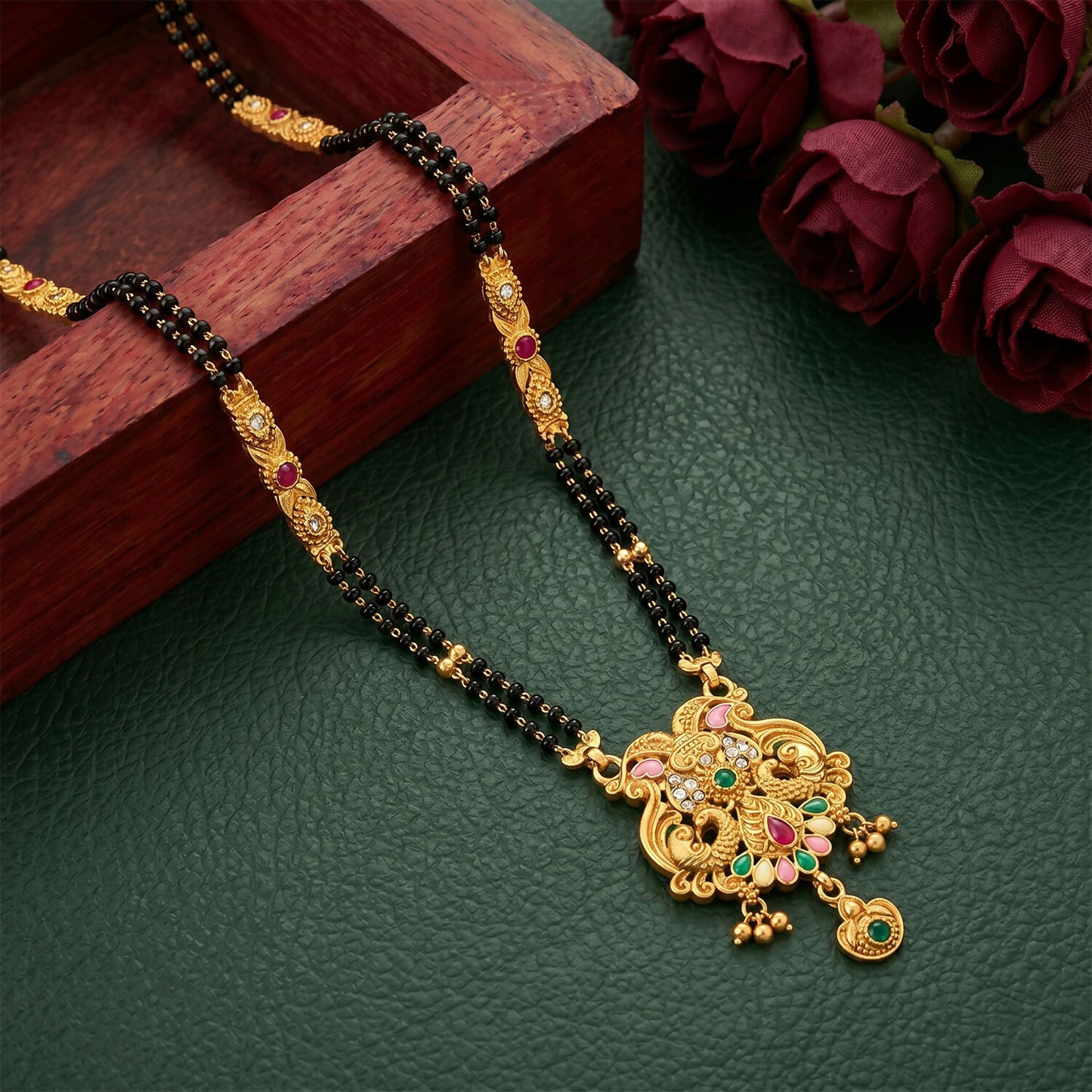 Detailed view of Makara dragon motifs and teardrop stone on mangalsutra pendant