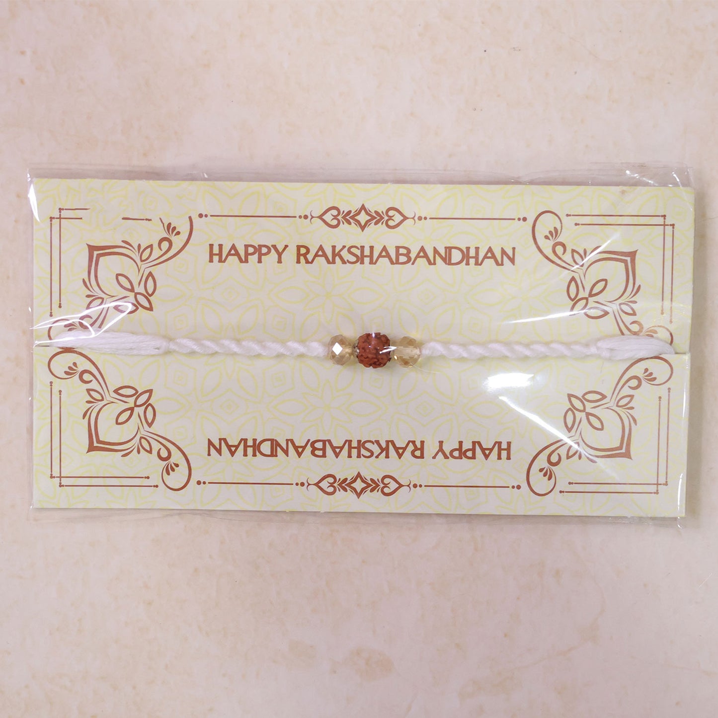 White Thread Rakhi with Rudraksha Bead and Sparkling Crystal Accents