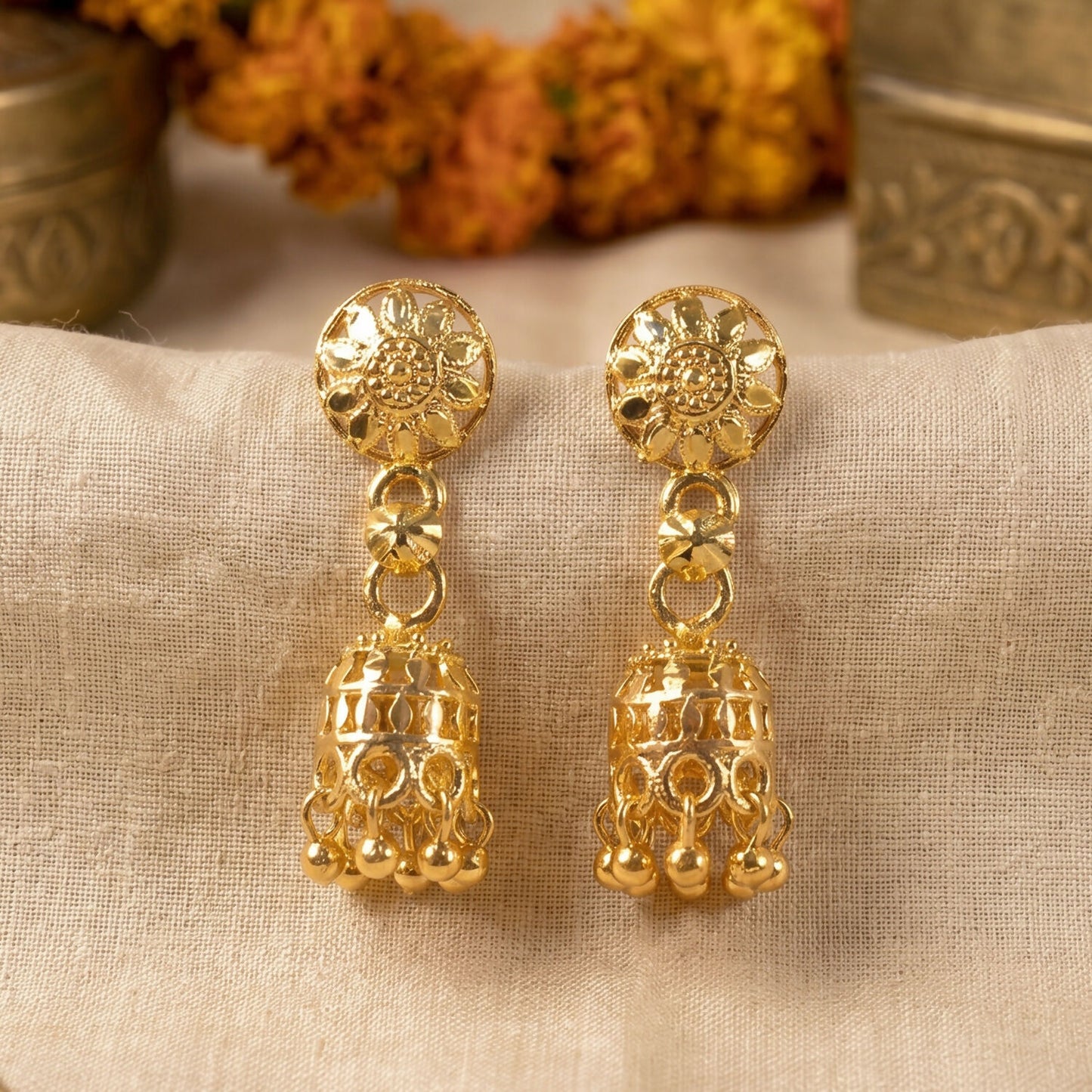 Jhumka earrings displayed on white background highlighting intricate design