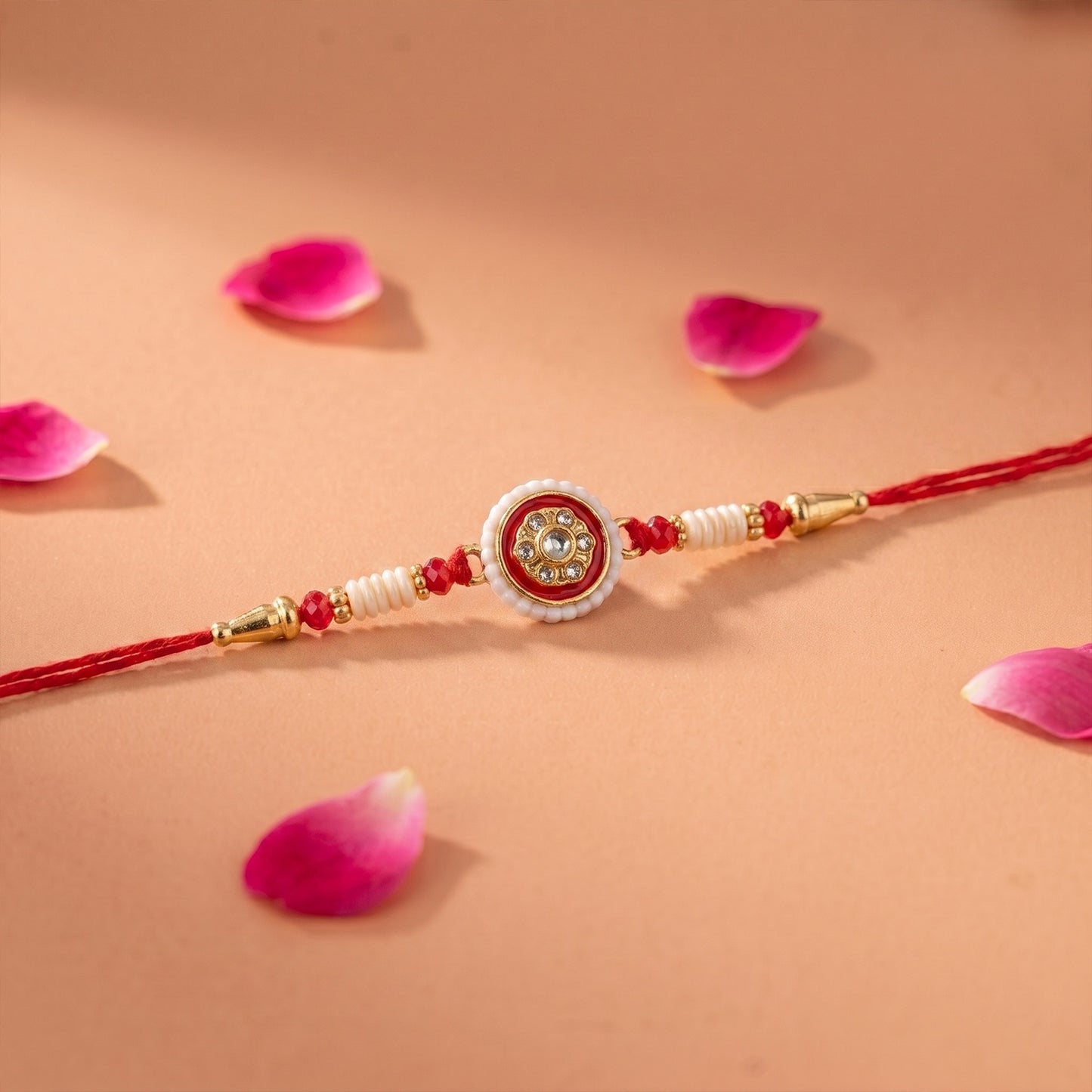 Designer red Rakhi with pearl and bead accents