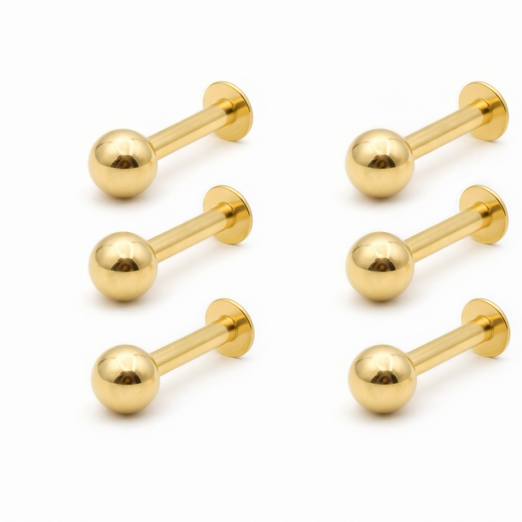 Set of six gold nosepin studs laid out to display matching traditional design.