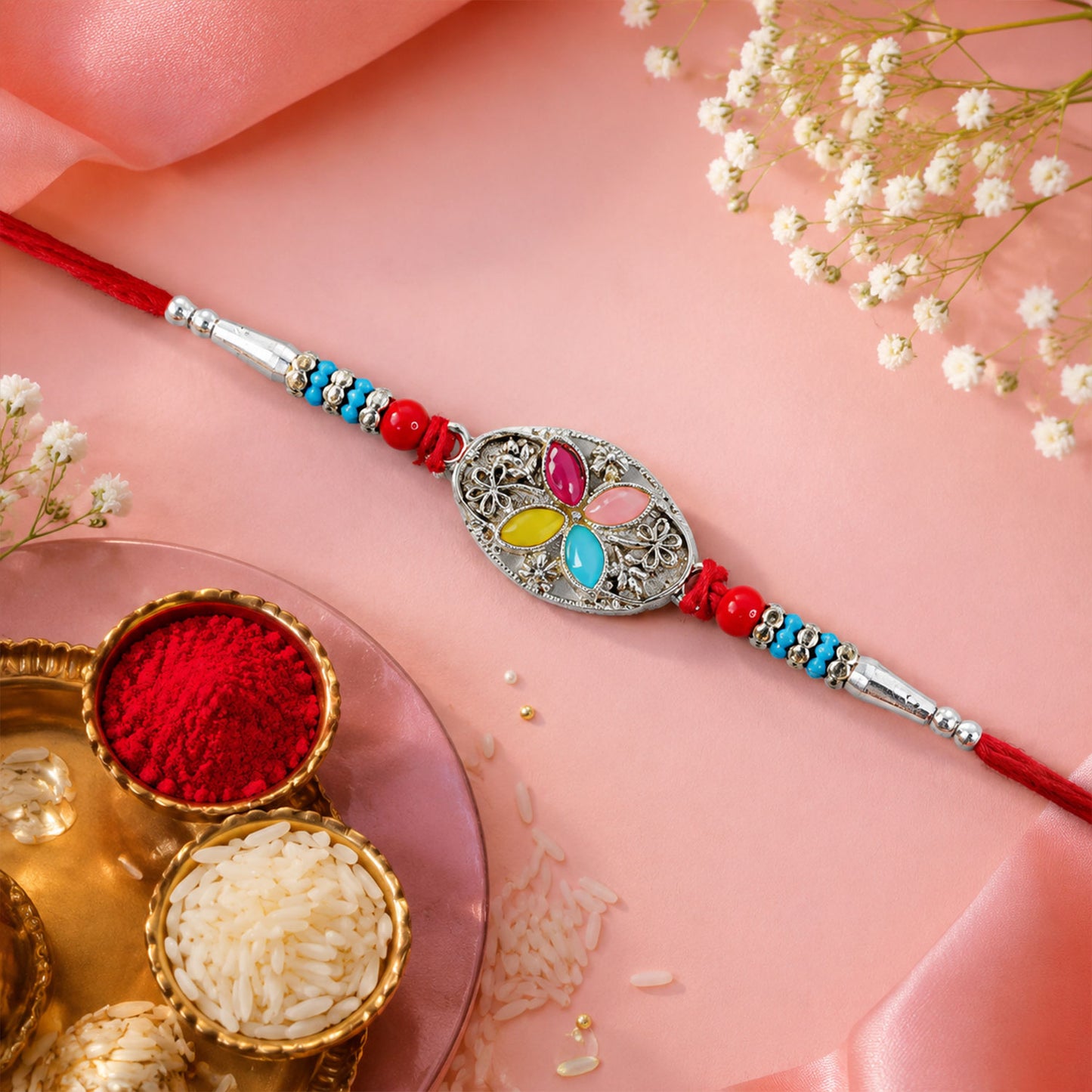 Silver Oval Floral Stone Rakhi with Color Petal Centre, Roli Chawal Coin and Card Packing