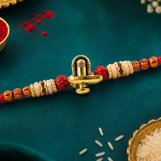 Close-up of Lord Shiva Rakhi with Shivling and Trishul design.