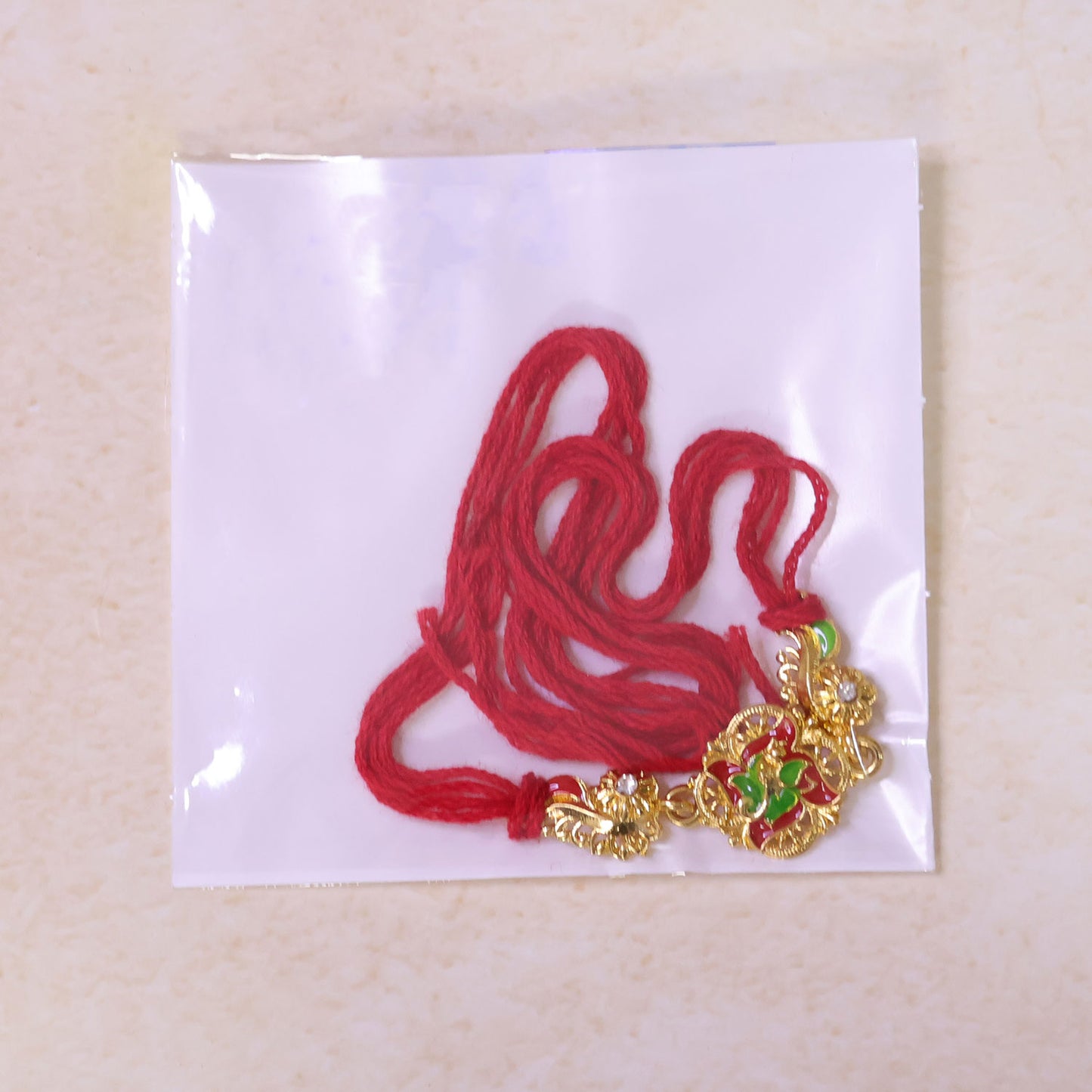 Ornate Rakhi featuring Floral Medallion, multicolor stones and gift style for Gift