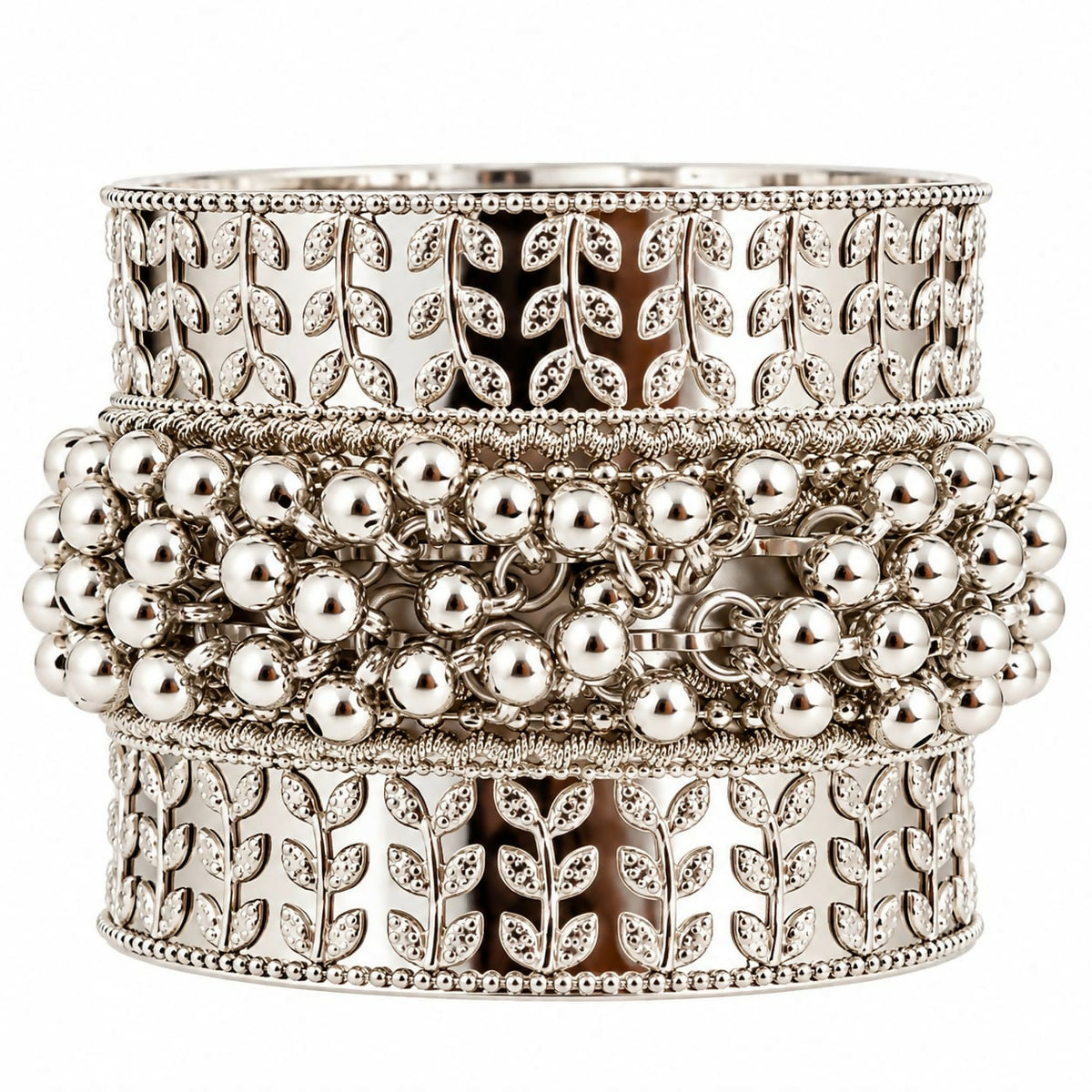 A wide, ornate silver-tone kada bangle with embossed leaf motifs and a central row of small, spherical ghungroo beads.