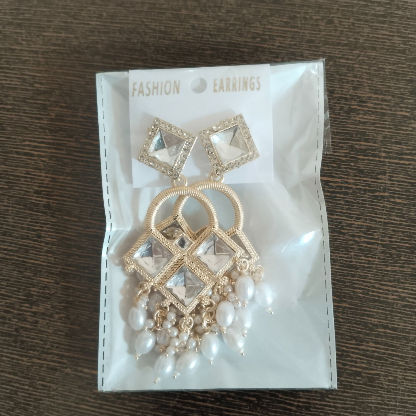 Detailed view of textured arch and micro-pavé accents on Kundan chandelier earrings