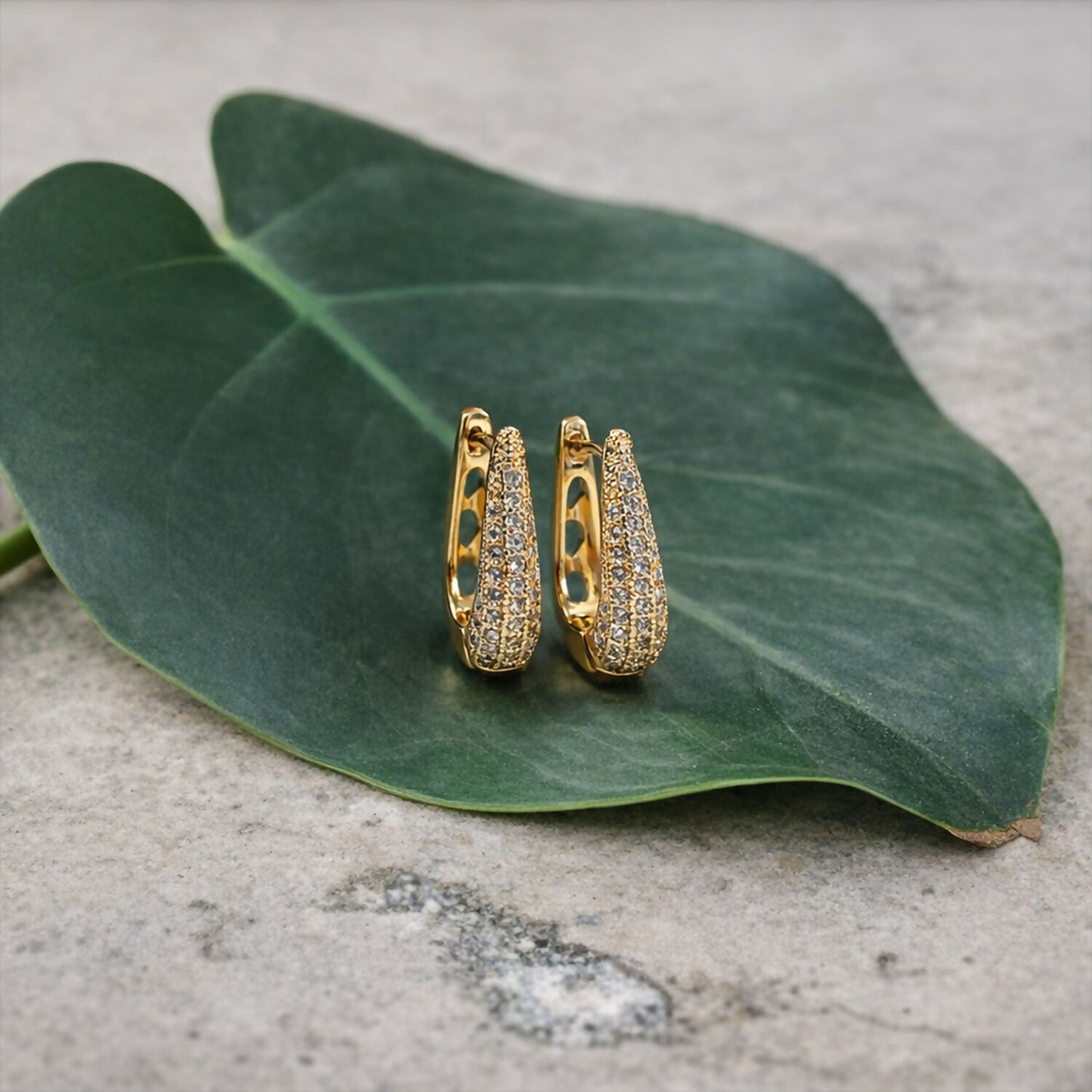 Elegant Curved Pavé Crystal Huggie Earrings in Gold Finish