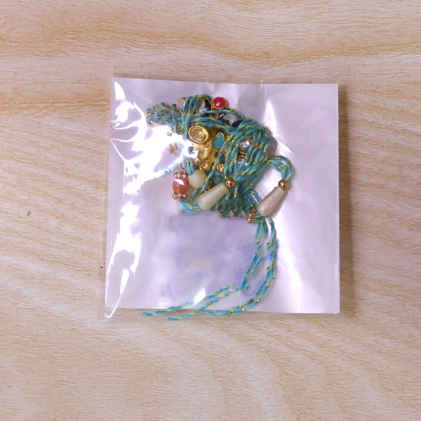 Festive Rakhi featuring Ornate Floral Charm and bead line in gift style for Gift Use