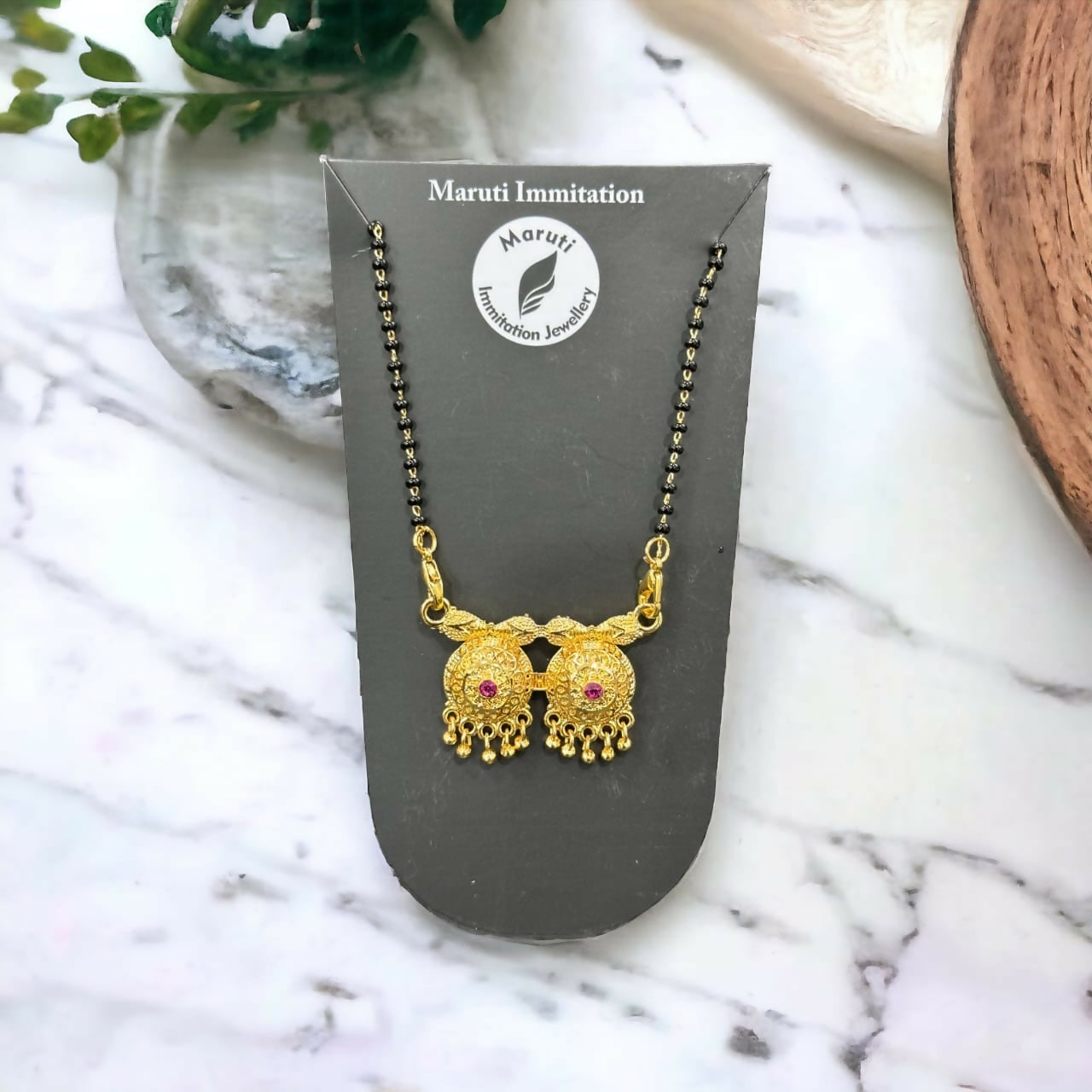 The The Eternal Embrace mangalsutra. The elegant pendant is made of high-quality gold-plated brass.