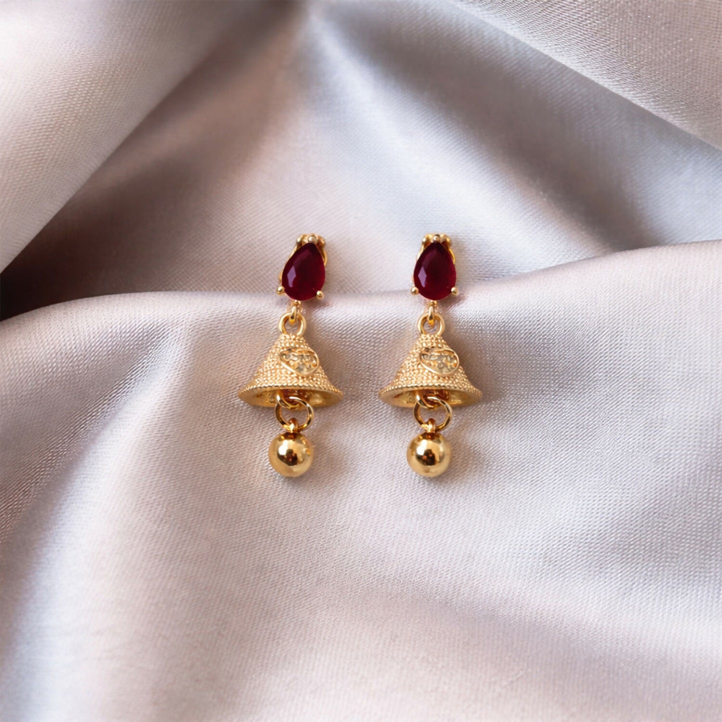 Ruby teardrop jhumka earrings paired with traditional Indian attire