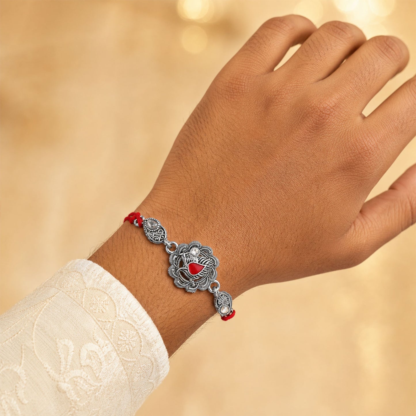 Ornate Rakhi featuring Silver Round Charm, metal trims and chain look for Gifting