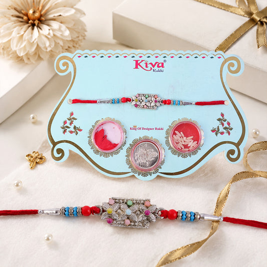 Close-up of the rectangular pearl crystal rakhi with red and blue beads.